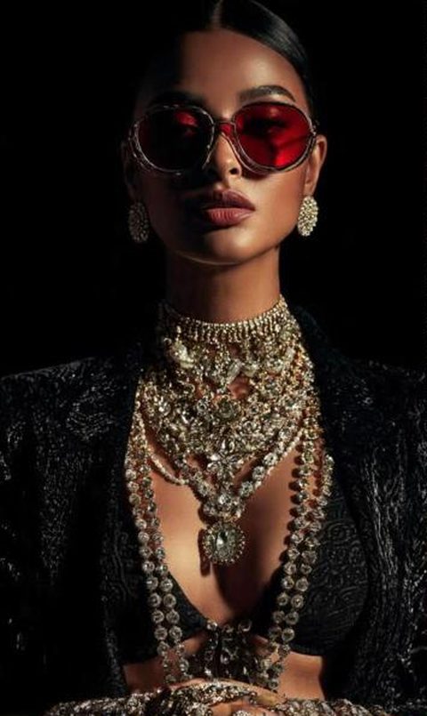 Red-lensed sunglasses with layered polki jewellery