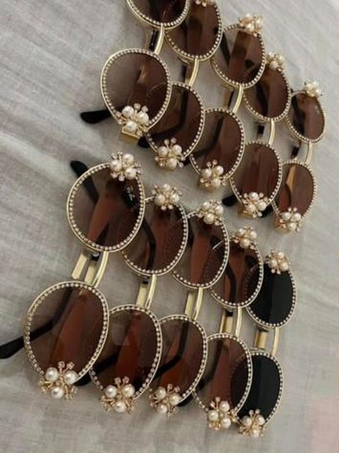 Pearl-trimmed round sunglasses laid out in rows